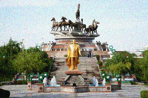 The golden statue of President Saparmurat Niyazov, (known as Turkmenbashy) stand a mid a fountain in front of the Ahal Tekke Horses Monument in the Ten Years of Independence Park in central Ashgabat